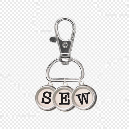 Patchwork with Busyfingers enamel charm typewriter keys spelling SEW with a silver lobster clasp.