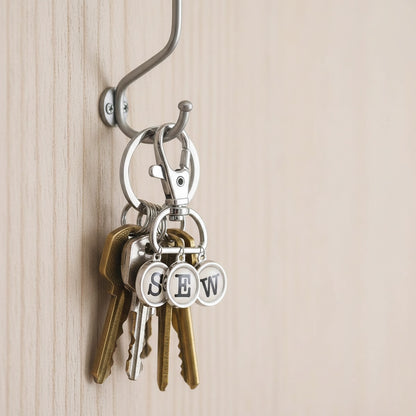 Patchwork with Busyfingers enamel charm typewriter keys spelling SEW with a silver lobster clasp.
