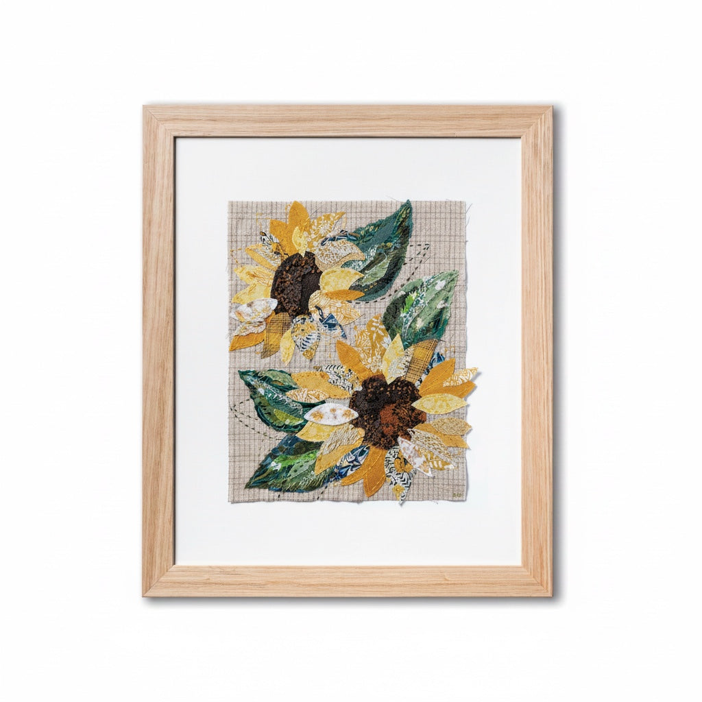 Patchwork with Busyfingers Sun Flower slow stitching kit featuring fabric sunflower collage in a light wood frame.
