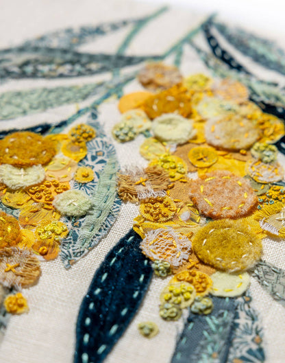 Close-up of Patchwork with Busyfingers Wattle Glow slow stitching kit featuring textured yellow floral fabric applique
