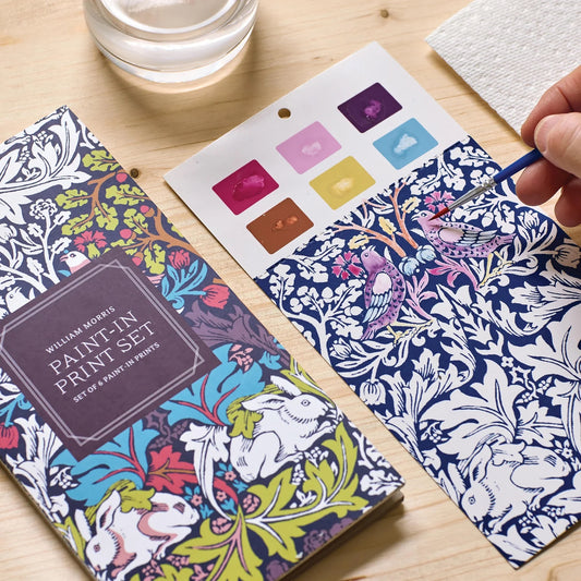 Patchwork with Busyfingers William Morris Paint-in Print Set featuring a paint palette with 6 colours and a brush painting a bird on patterned paper.