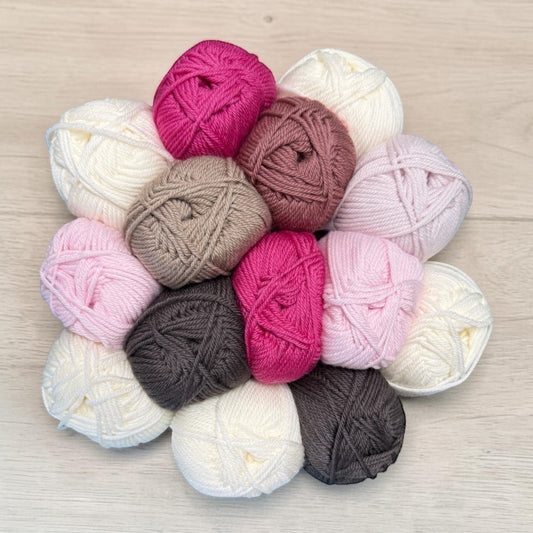 Patchwork with Busyfingers Blushing Stone Wool Yarn Set, 28 balls of 100% Australian Merino wool in White, Copper, Lipstick, Petal, Coral, Rock, and Butter shades.