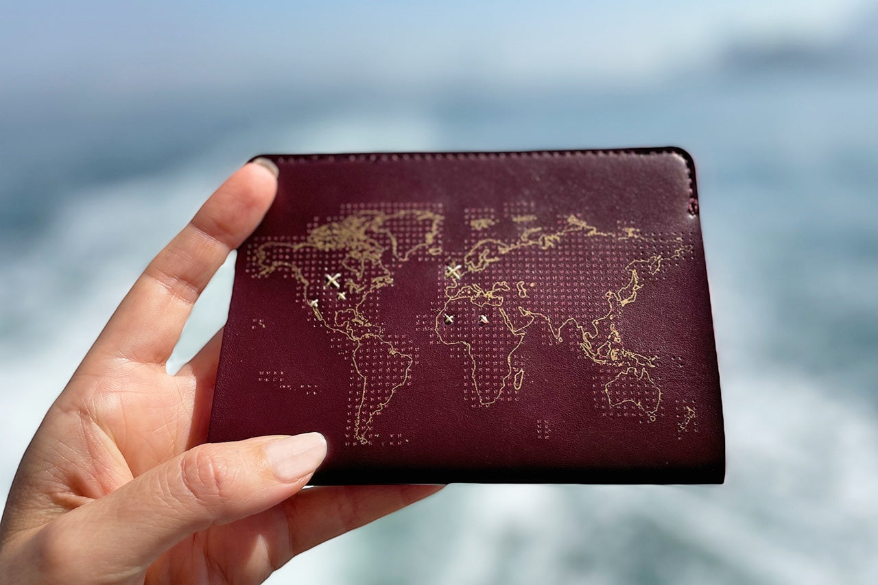 Patchwork with Busyfingers maroon leather passport cover kit with gold world map and stitch marks.