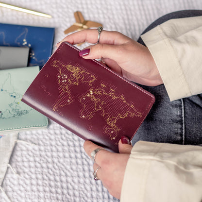 Patchwork with Busyfingers maroon leather passport cover with gold world map design and stitching detail.