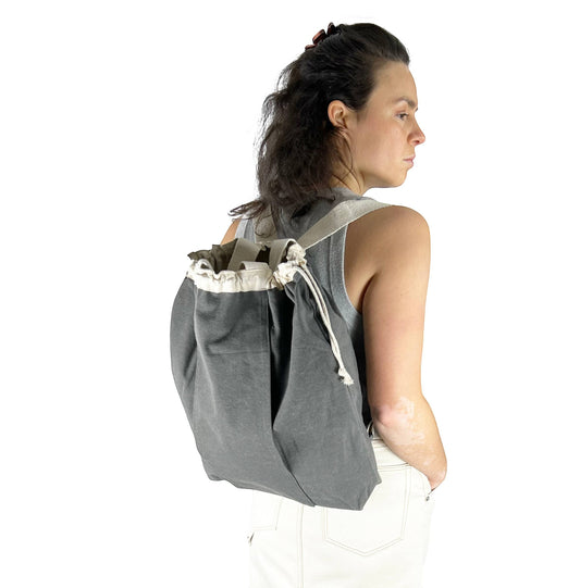 Patchwork with Busyfingers olive washed canvas backpack with drawstring closure and adjustable straps.