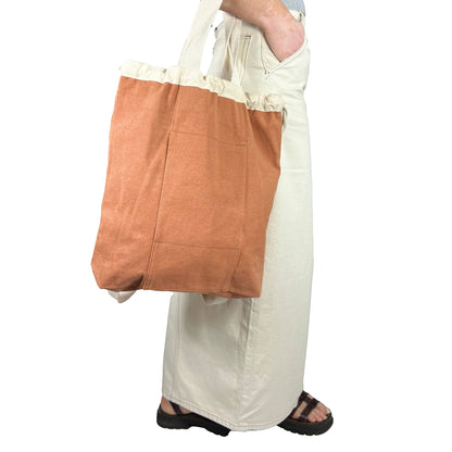 Patchwork with Busyfingers rust washed canvas tote bag with drawstring closure and front pockets. Natural canvas straps.