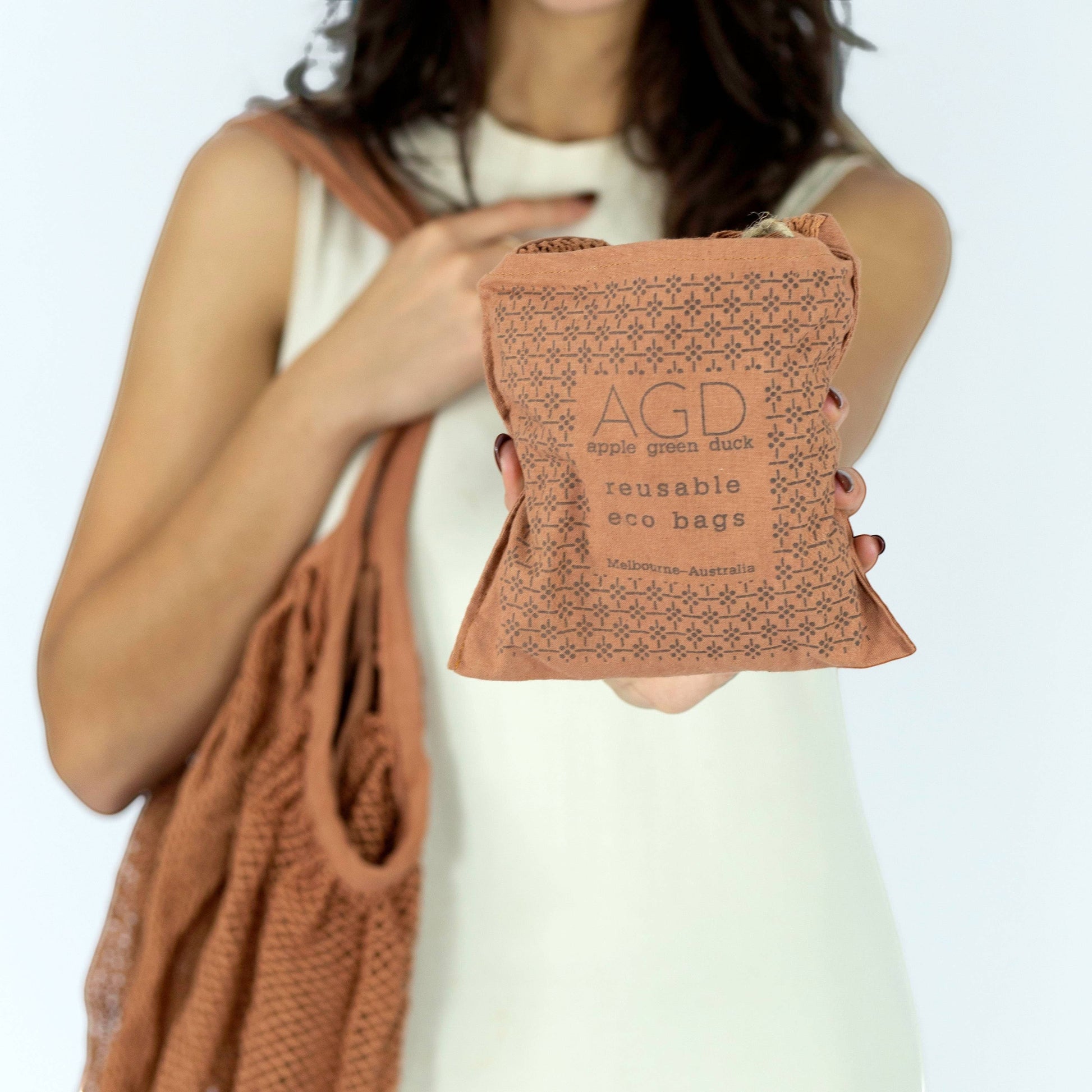 Patchwork with Busyfingers rust 100% cotton crescent net bag with long handles, folds into a pouch.